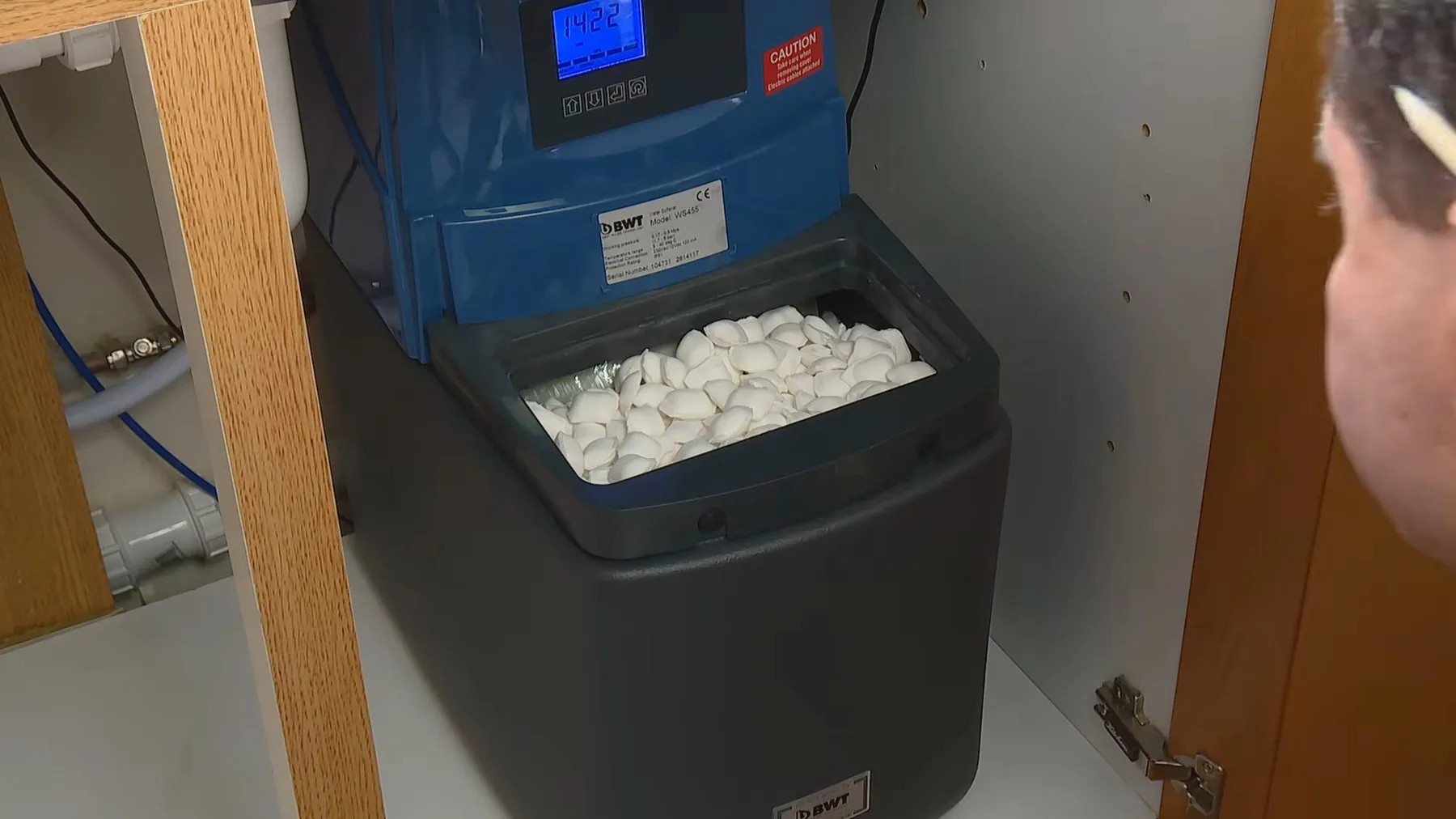 Salt being added to a water softener's brine tank