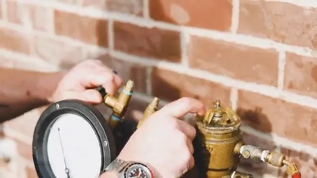 Brass backflow prevention device test cock being adjusted