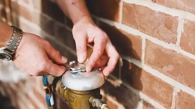 Test gauge being attached to a backflow preventer for compliance testing