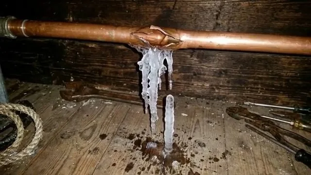 Burst copper pipe with ice formed around the failure point