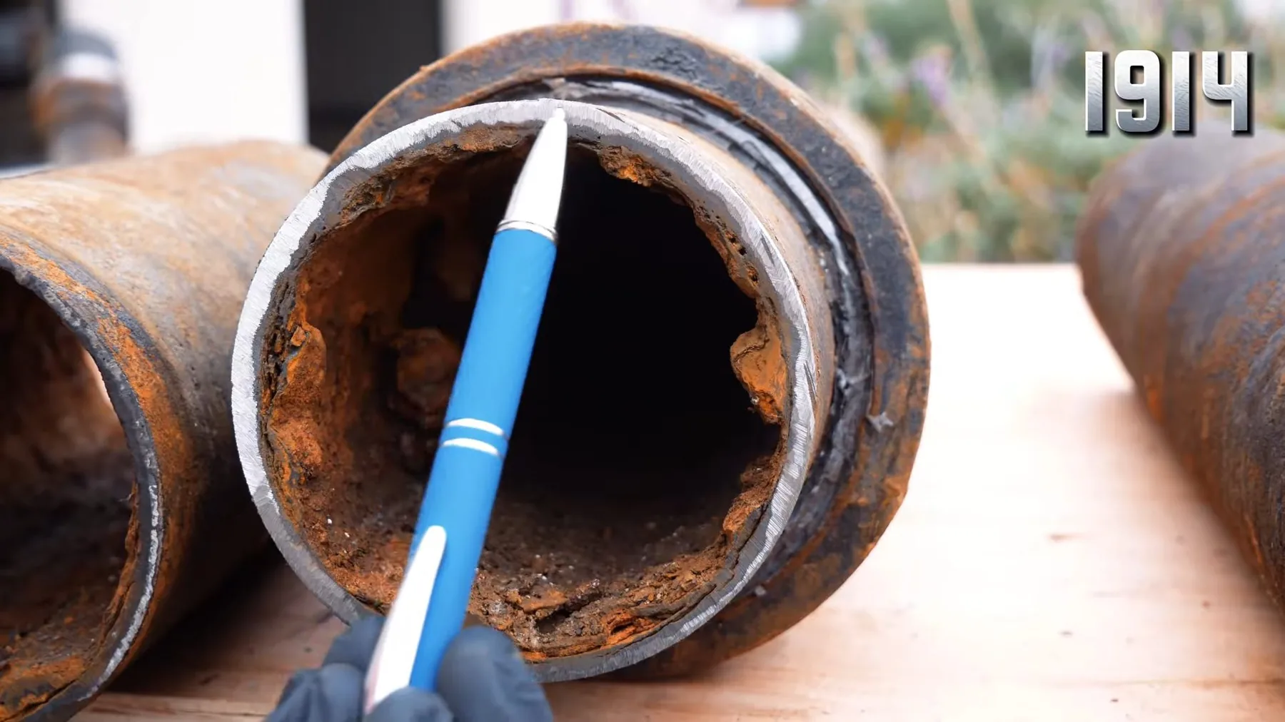 Interior of an old cast iron pipe alongside a comparison sample