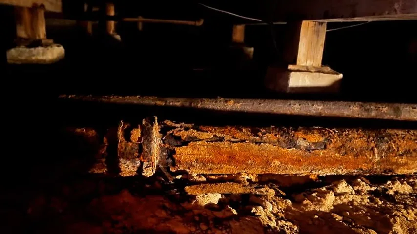 Cast iron sewer section showing heavy internal corrosion buildup
