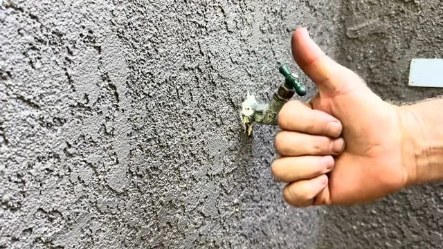Outdoor hose bib handle being checked after a repair