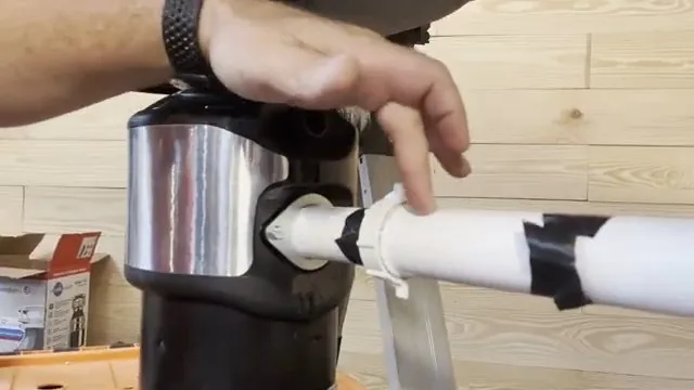 Dishwasher drain hose being connected to a garbage disposal