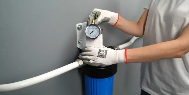 Water lines being connected to a filtration system's housing