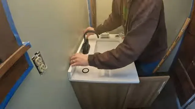 Contractor planning a bathroom remodel layout on site