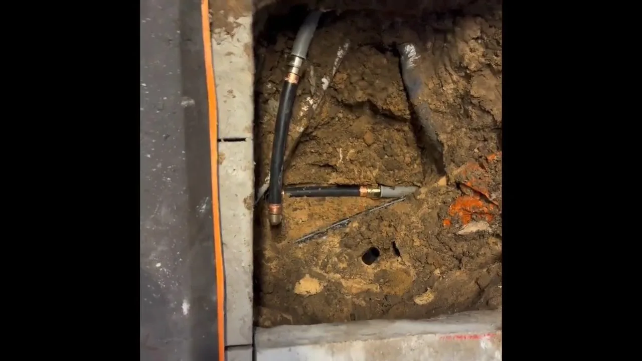 Copper water pipe laid in an open floor trench during repiping