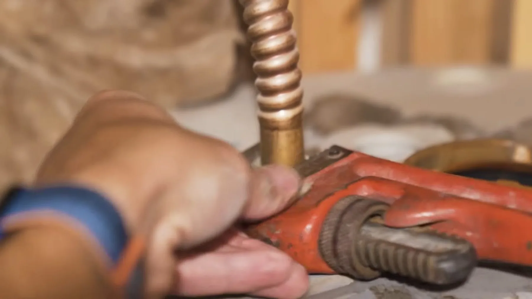 Copper supply tube being cut during a water heater repair