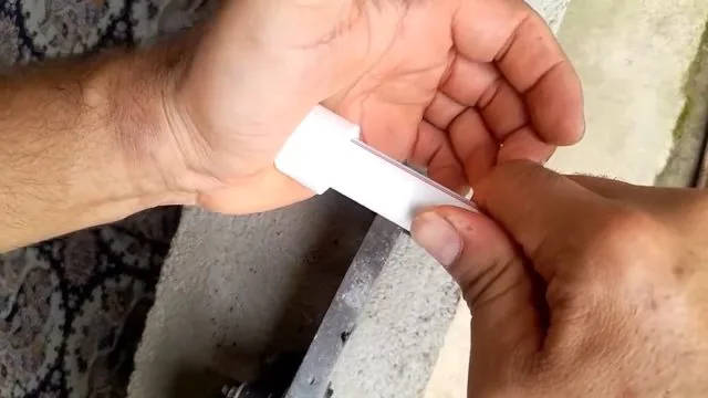 PEX repair tube being cut to length for a pipe section