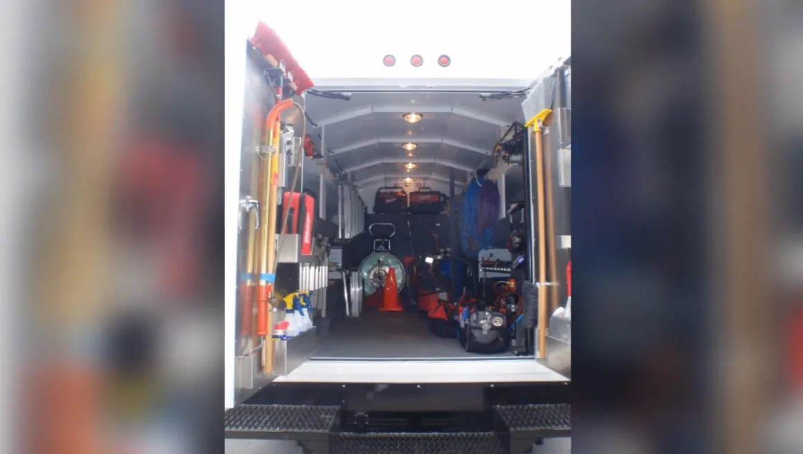 Interior of an emergency plumbing service van stocked with equipment and parts