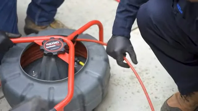 Inspection camera being fed into a sewer cleanout access point