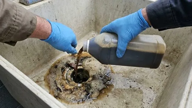 Foaming reaction from a baking-soda-based drain treatment inside a clogged pipe