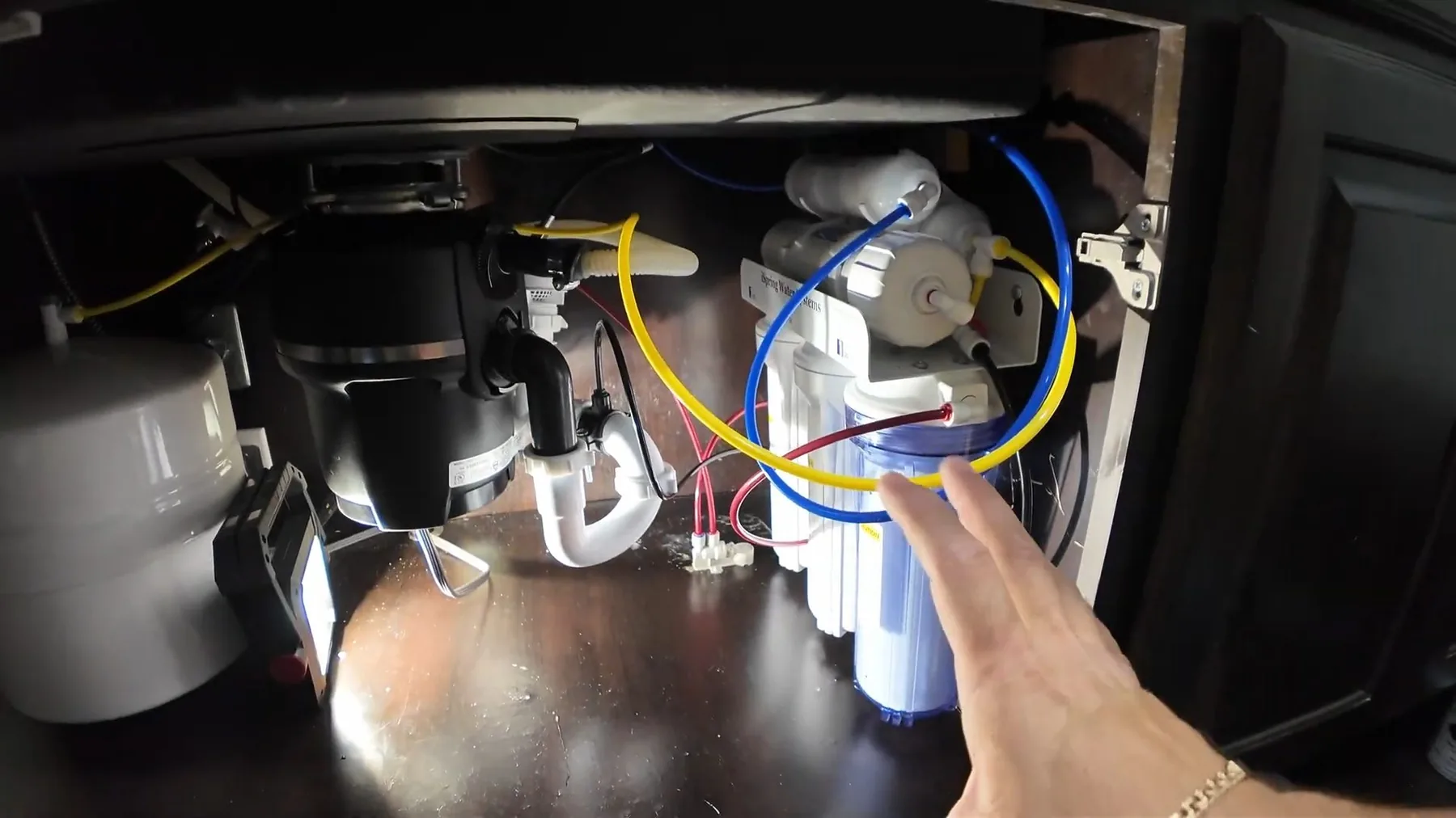 Garbage disposal wiring routed inside a sink cabinet