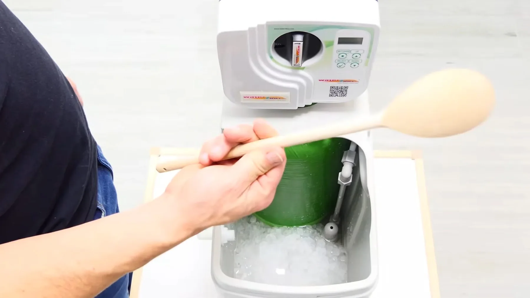 Resin-bed cleaner being added to a water softener tank