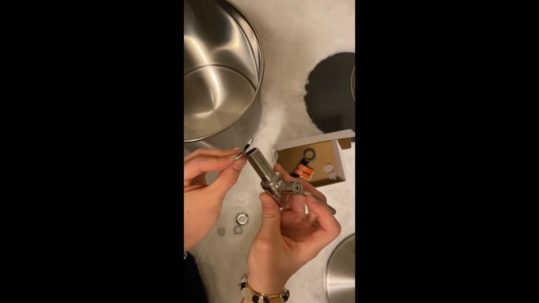 Spigot being assembled onto a gravity-fed water filter