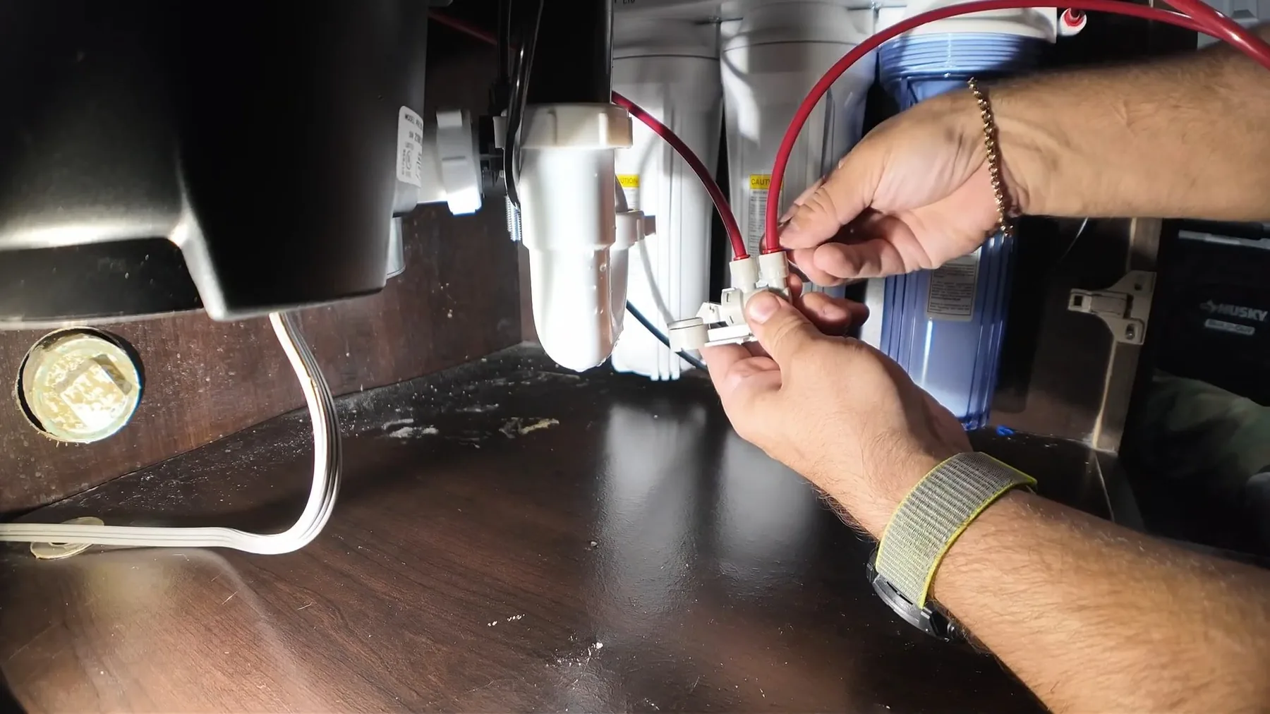 Wires being connected to a garbage disposal unit by hand
