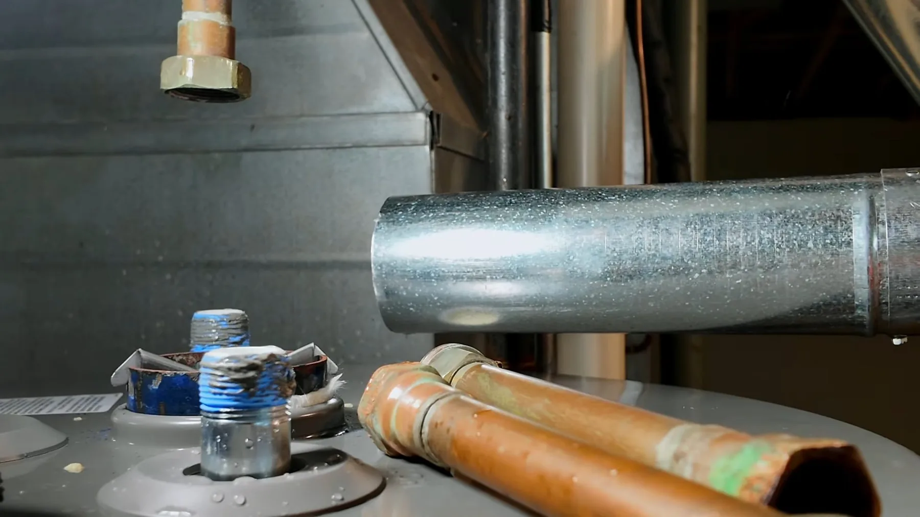 Hot water supply pipes running above an installed water heater