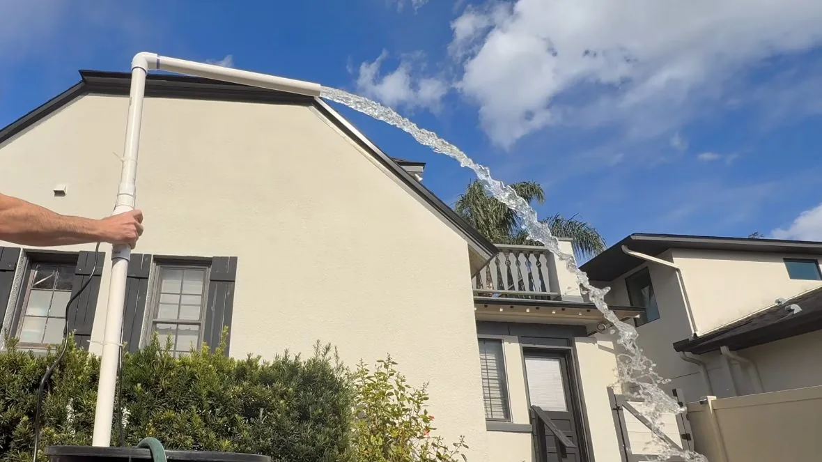 House exterior showing a wall-mounted tankless water heater installation
