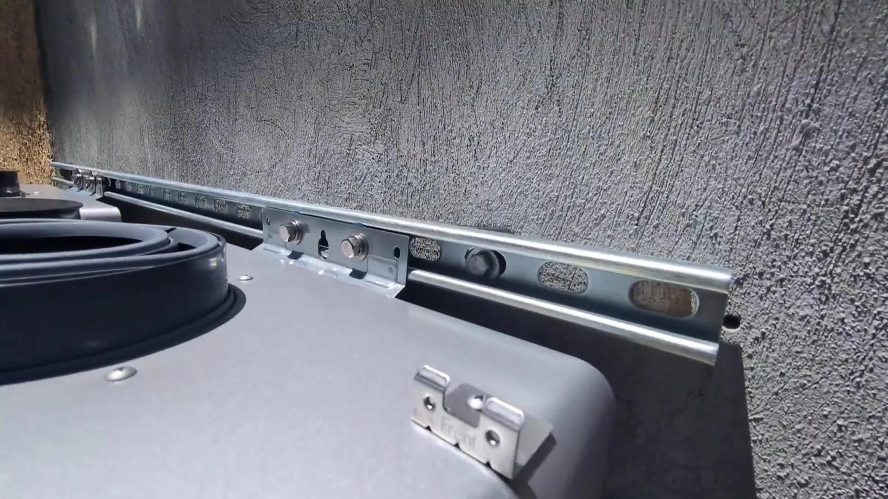 Mounting bracket for an outdoor tankless water heater installation
