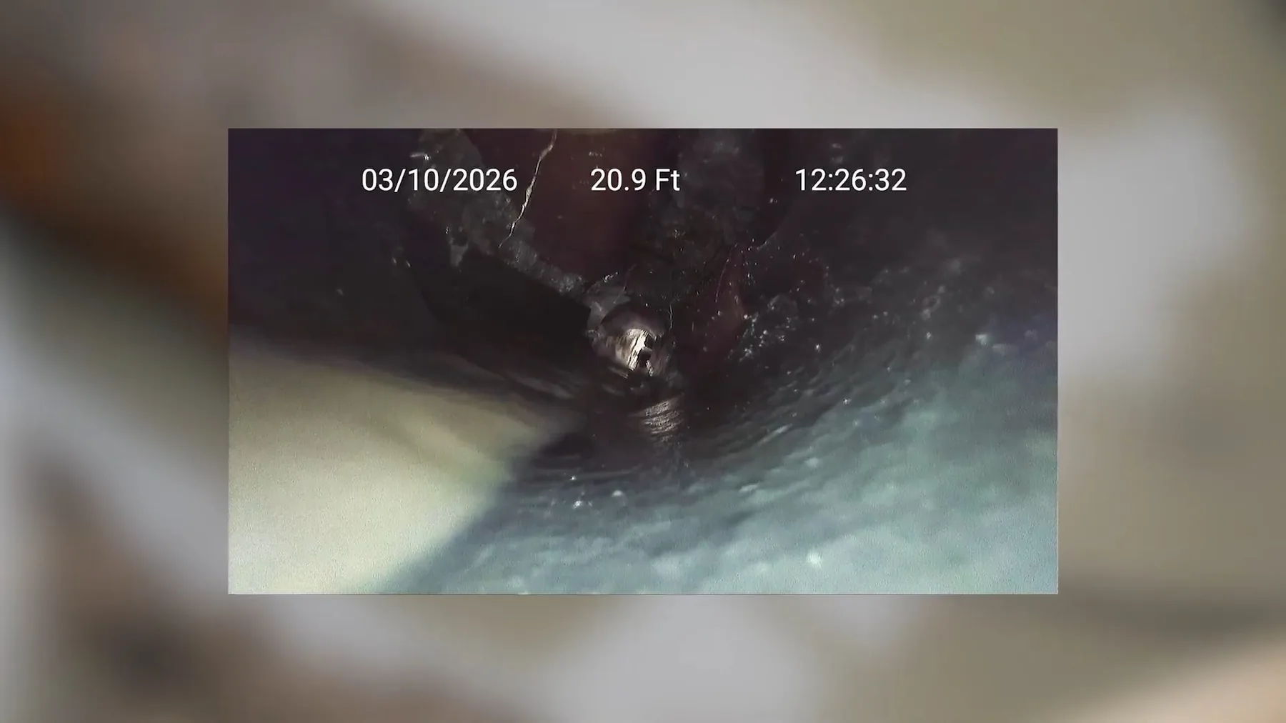 Camera view of the interior of an older cast iron sewer line