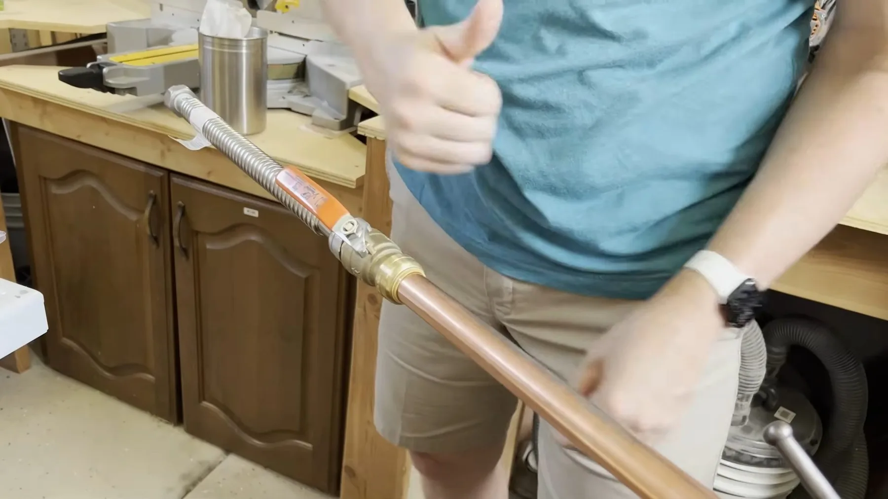 Plumber installing a pipe section as part of a water heater repair