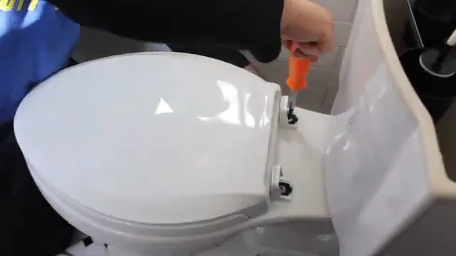 Plumber working beside a toilet during a bathroom remodel