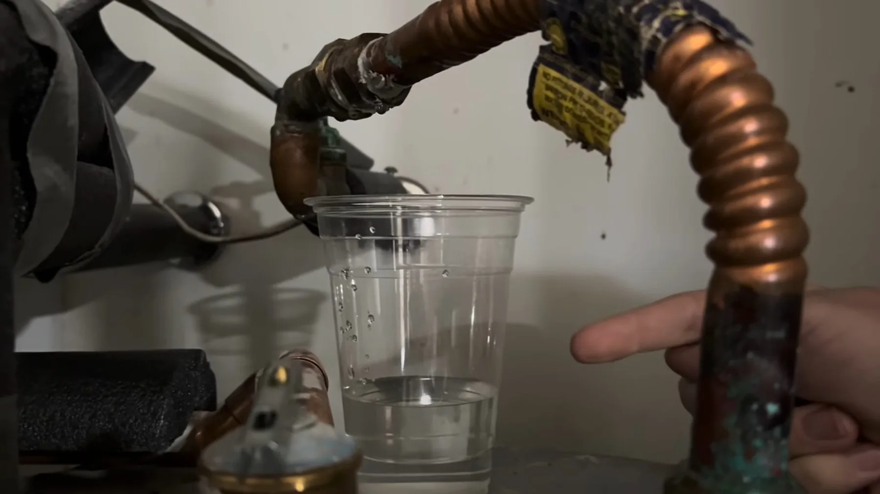 Water being poured into a hose connection during water heater service