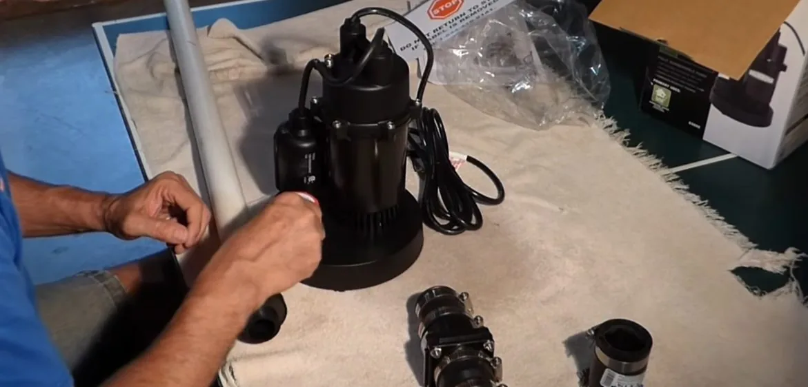 Sump pump components laid out ahead of installation