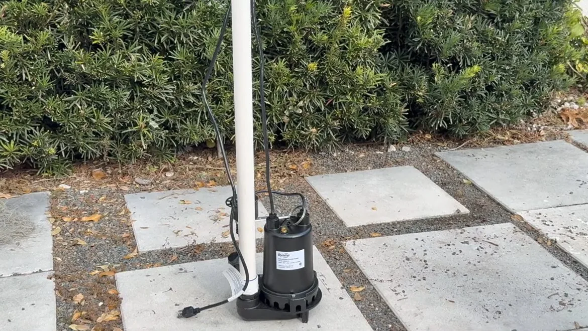 Sump pump discharge line routed to the outside of a house
